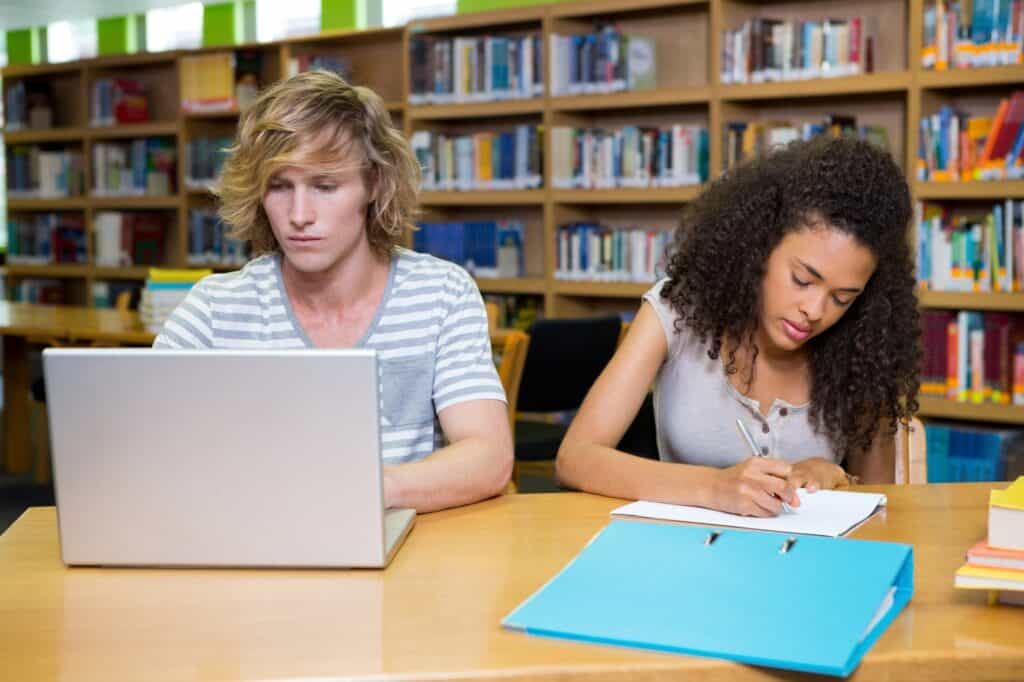 High school students studying together in the library