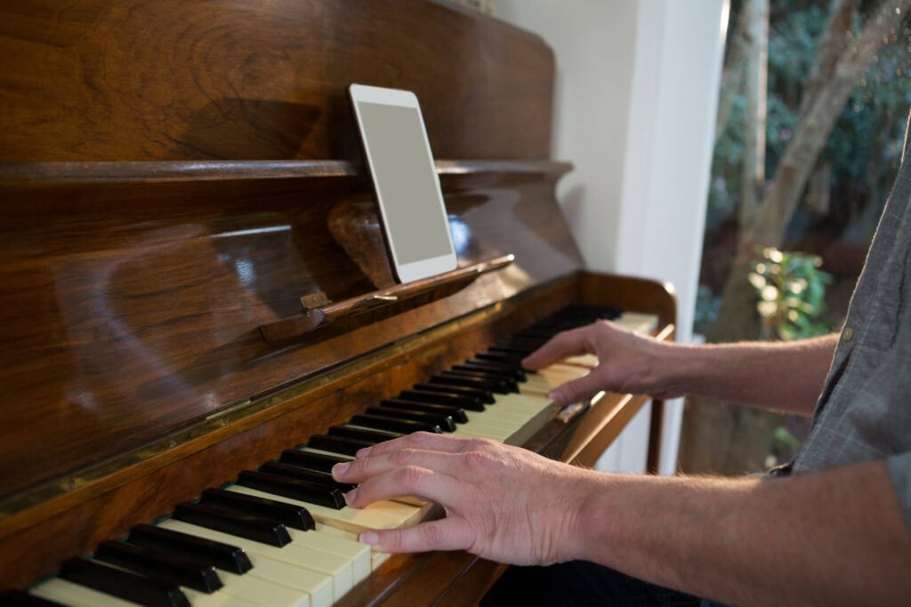A man is playing piano at home